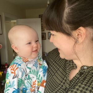 Mum holding her smiling baby face to face